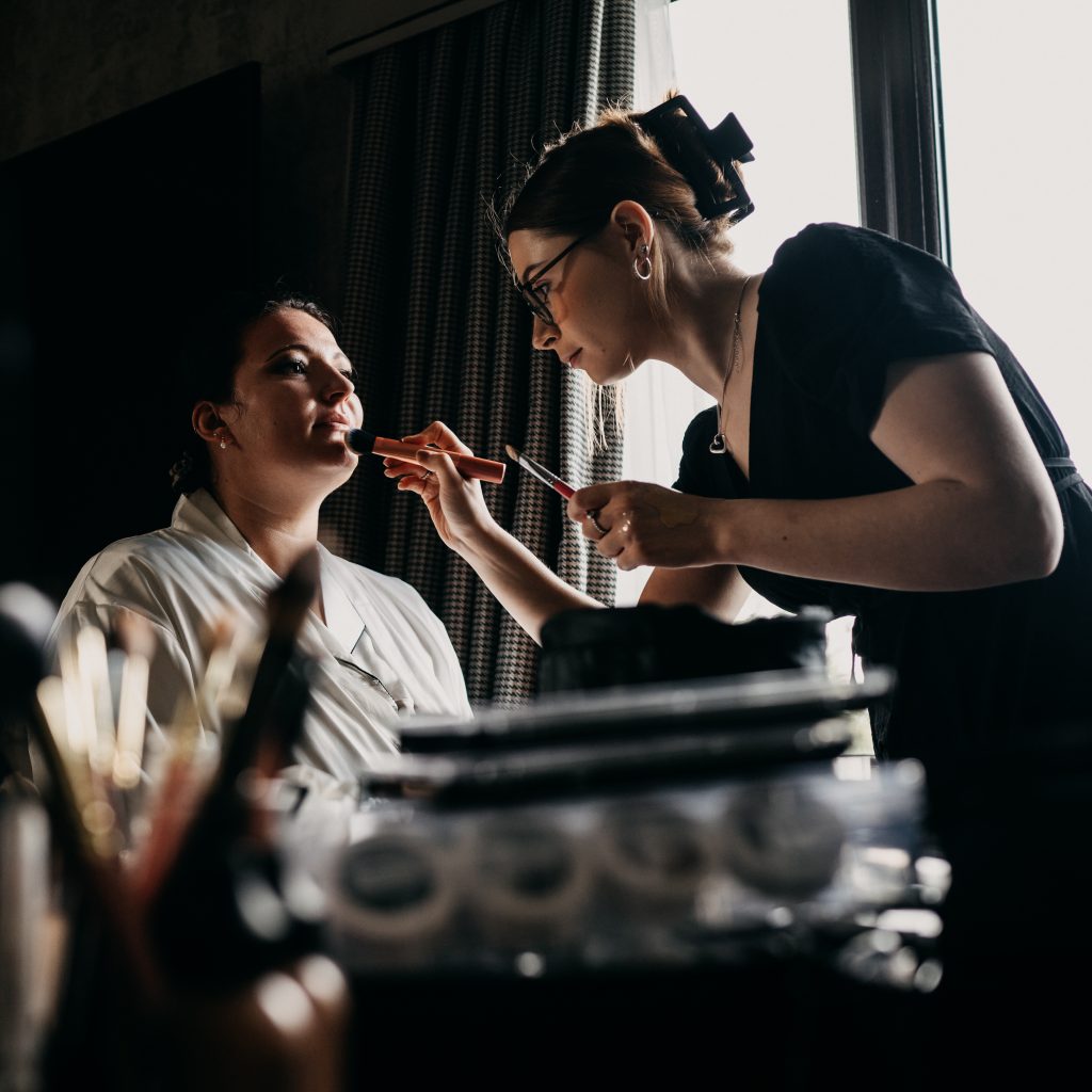 Zeta Hoyes applying makeup to female client